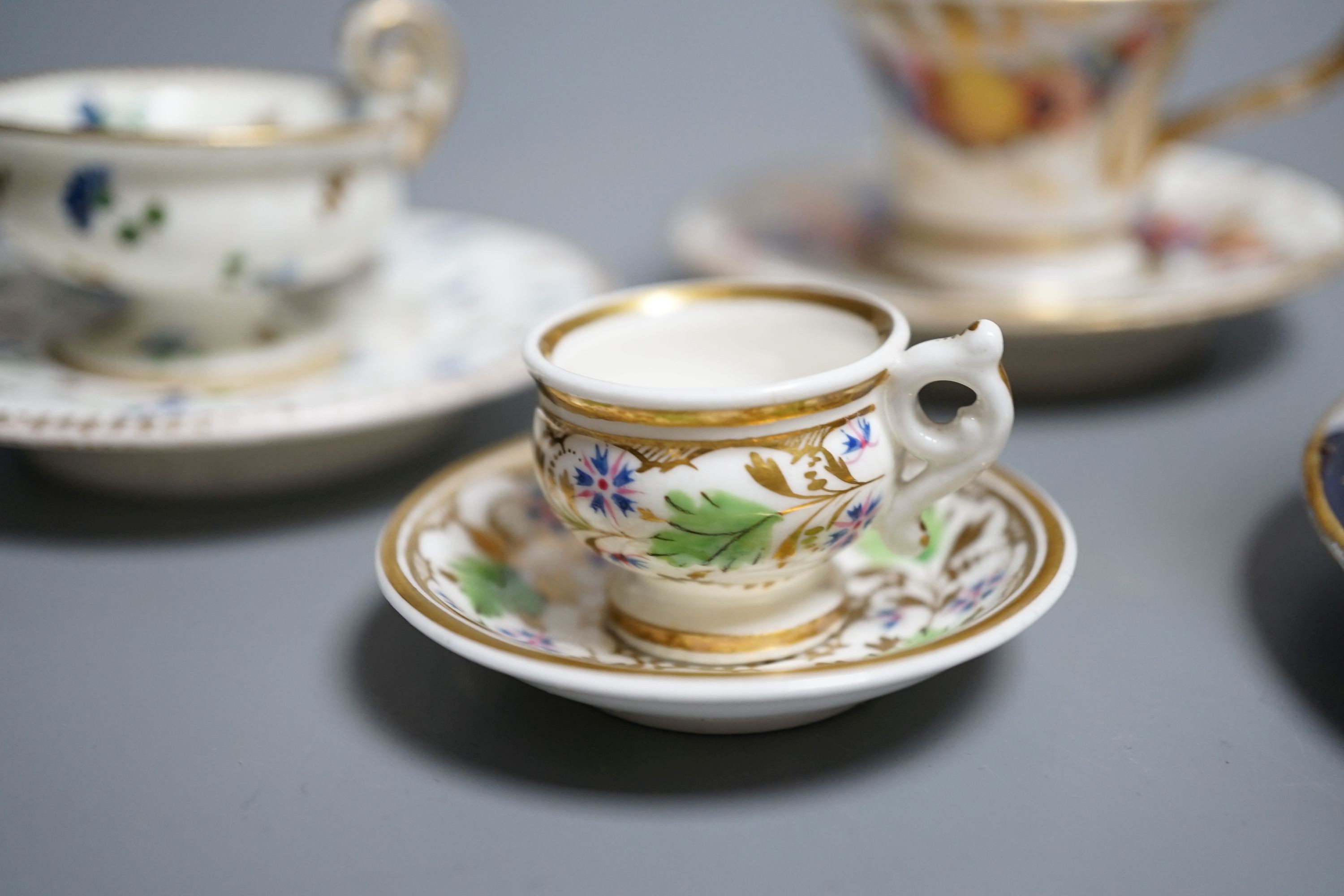 Four Coalport miniature teacups and saucers, c. 1820. Provenance - Mona Sattin collection of miniature cups and saucers, collection no.s 102, 103, 104 and 106.